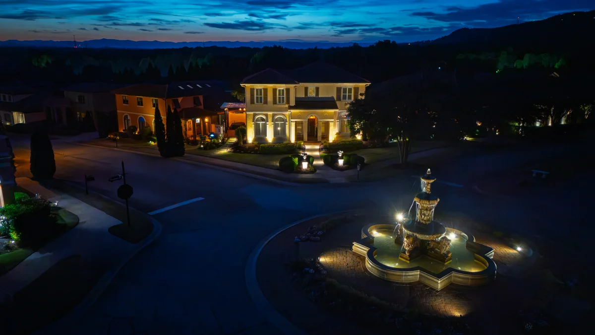 Greenville SC landscape lighting illuminating Italian style home and luxury fountain at night